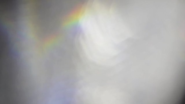 Light leaks and lens flare wipes with silver and holographic iridescent bokeh.