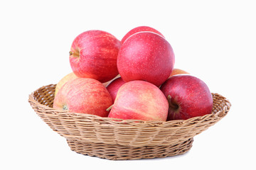 Fresh red apples in a basket, isolated on white