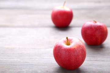 Fresh red apples on a grey wooden background