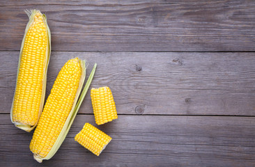 Fresh corn on a grey wooden background
