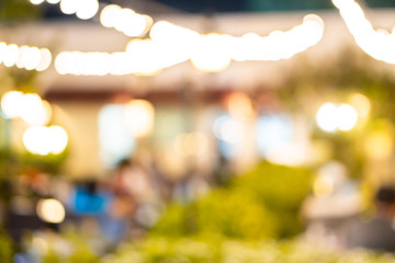 Blurred bokeh light of outdoor luxury restaurant, night party festival drink background