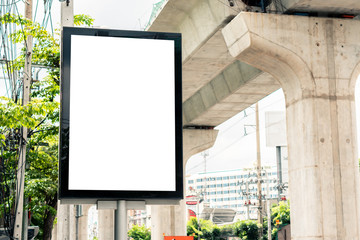 blank street billboard in urban road city area with skytrain rail line in the background , isolated...
