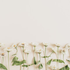 Naklejka na ściany i meble Flowers pattern on beige background. Flat lay, top view.