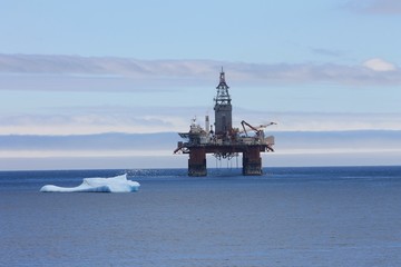 Iceberg floating by an oil rig in the North Atlantic, Bay Bulls, Newfoundland