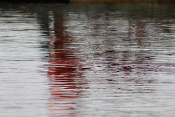 Reflection on the pond of people standing on a dock, Eastport, Newfoundland and Labrador, Canada