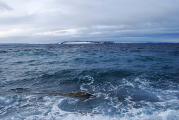 View across Conception Bay to Kelly's Island, Conception Bay, Newfoundland. Rough seas, cloudy sky.