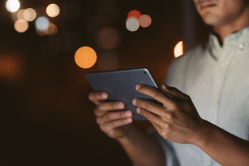 Businessman working with a tablet in an office at night