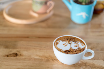 Hot coffee cup on wooden table