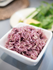 Close up of freshly cooked purple or black rice in a bowl. High in nutrients and good source of vitamin, mineral, antioxidant, anthocyanin, high in fiber. Healthy eating and eat well concept.