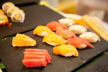 Assortment of tasty and delicious Sashimi and Sushi. Most popular Japanese food. Sashimi is raw fish and seafood. Sushi is raw seafood on top of vinegared rice. Healthy eating and eat well concept.