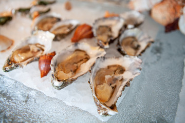 Tasty fresh oysters close-up on ice. Raw oysters are packed with nutrition, high in calcium, potassium, magnesium, vitamin and mineral. Flavor are sweet and refreshing. Believed to be an aphrodisiac.