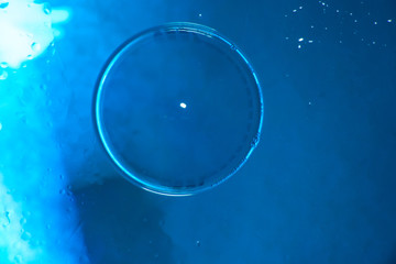 Bright blue background with soap bubble on top