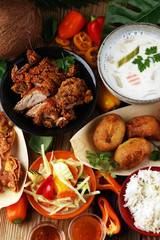 Chinese food with fried duck with curry sauce. tom kah kai soup, dumplings and rice. Fried banana and vegetables. Street food with wan tan.