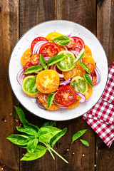 Tomato salad. Fresh vegetable salad with tomatoes, onion and basil