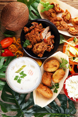 Chinese food with fried duck with curry sauce. tom kah kai soup, dumplings and rice. Fried banana and vegetables. Street food with wan tan.