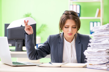 Young female employee very busy with ongoing paperwork