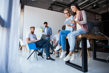 Office life. Group of young business people working and communicating together in creative office.