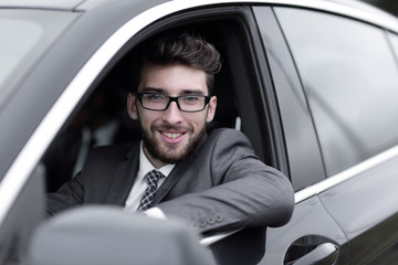 businessman in suit driving his luxurious car.
