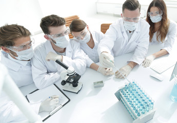 Fototapeta premium medical doctors are working with test tubes and microscope at the lab