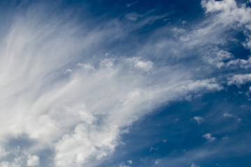 wispy clouds against a beautiful blue background