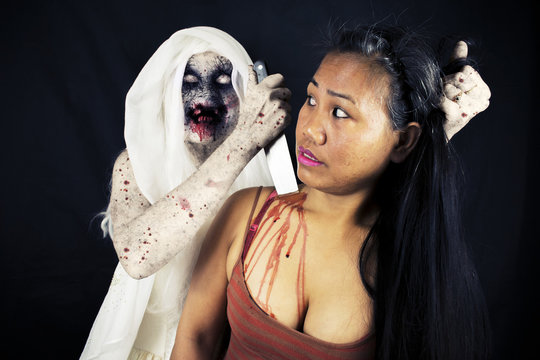 Evil Demon Zombie Ghost Monster Stabbing A Woman In The Neck Isolated On Black Background