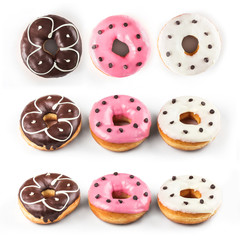 Obraz premium Donuts set isolated on white background. Different type of donuts: with chocolate, with pink and vanilla cream, top view