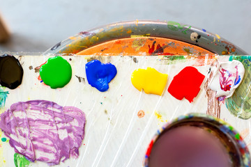 Top view of color palette with pints prepared for mixing and painting. Flat lay, Multicolored...
