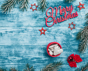 Christmas card. On azure background. Top view. Elements of winter holidays and fir branches.
