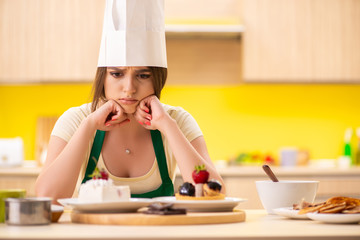 Young cook cooking cakes in the kitchen