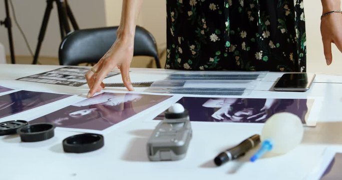 Female photographer standing at desk 4k