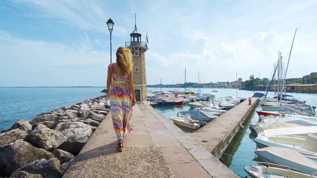 Beautiful girl goes to a lighthouse