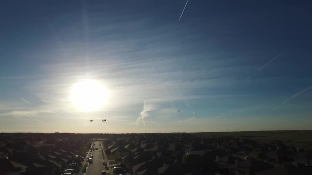Aerial footage of kites flying as the sun sets in the Sendera Ranch neighborhood in Haslet Texas, USA.