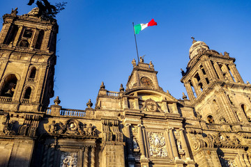 The Metropolitan Cathedral of Mexico City, with a Mexican flag flying above it