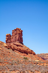 Fototapeta premium Iconic Southwest US desert brown sandstone monument in the former Bears Ear National Monument located in the Valley of the Gods, Mexican Hat, Utah