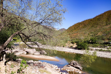 The calm Urique river, near the town of Urique at the base of the Urique Canyon, part of the Copper Canyon system in Chihuahua state, Mexico