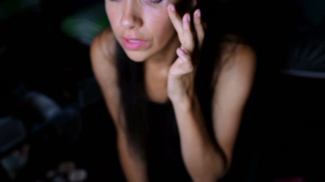 Female video blogger applying eyelash 4k