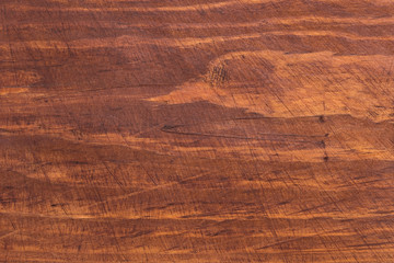 The surface of the wood cutting Board with traces of use.