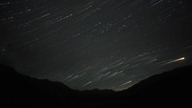 Long exposure time lapse of star trails over mountains in Kyrgyzstan