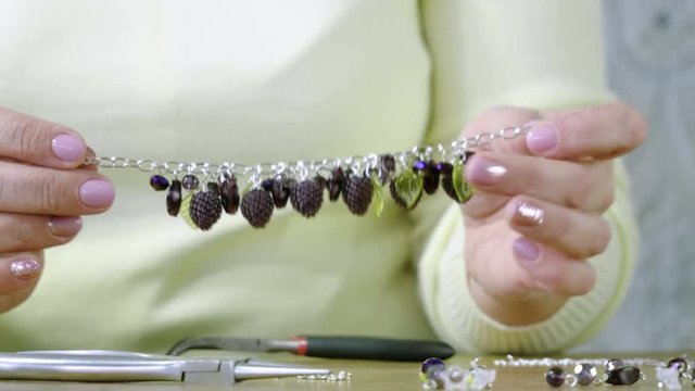 Unique handmade bracelet. Jewelry designer creating handmade jewelry in studio. 4K