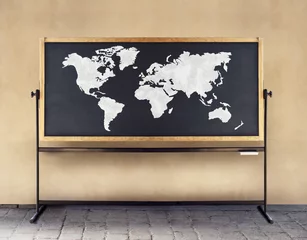 Selbstklebende Fototapeten Image of a world map drawn in white chalk on a blackboard © vali_111