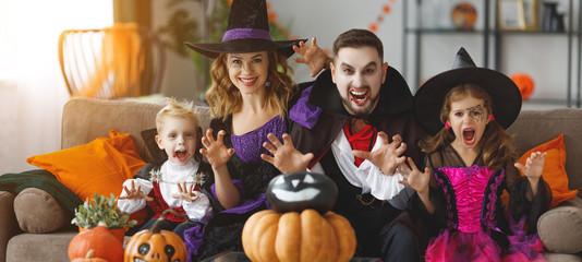 happy family mother father and children in costumes and makeup on  Halloween
