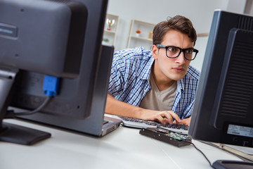 Young trader monitoring markets on screens