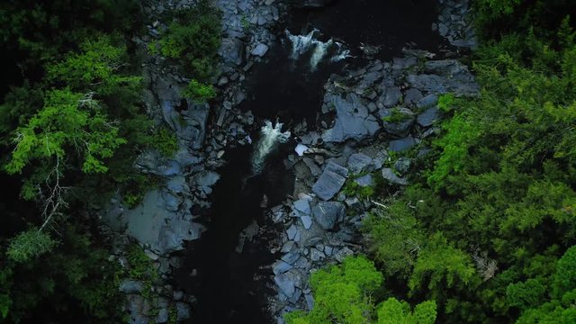 Aerial shot over Piscataquis River at Barrel Falls.