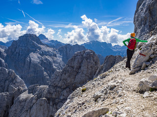 Fototapeta premium The mountaineer enjoying the view from the Prisank mountain in Julian Alps, Slovenia