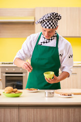 Young man cook preparing cake in kitchen at home 