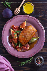 Duck breast with bacon, figs and rosemary. View from above, top studio shot