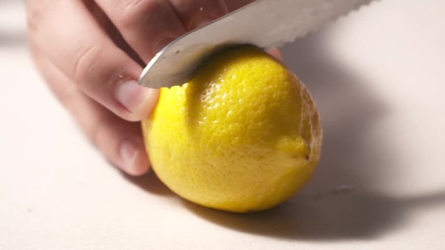 Slicing a lemon in half then snatching it away. Shot in high speed video.