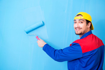 Young painter doing renovation at home 