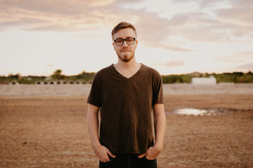 Handsome Young Male Model in Glasses and V-neck Modeling in Open Field Background