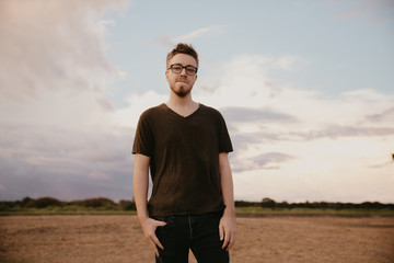 Handsome Young Male Model in Glasses and V-neck Modeling in Open Field Background